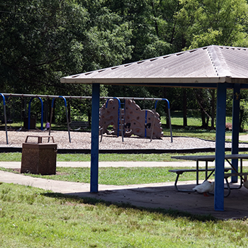 a park shelter with covered picnic area